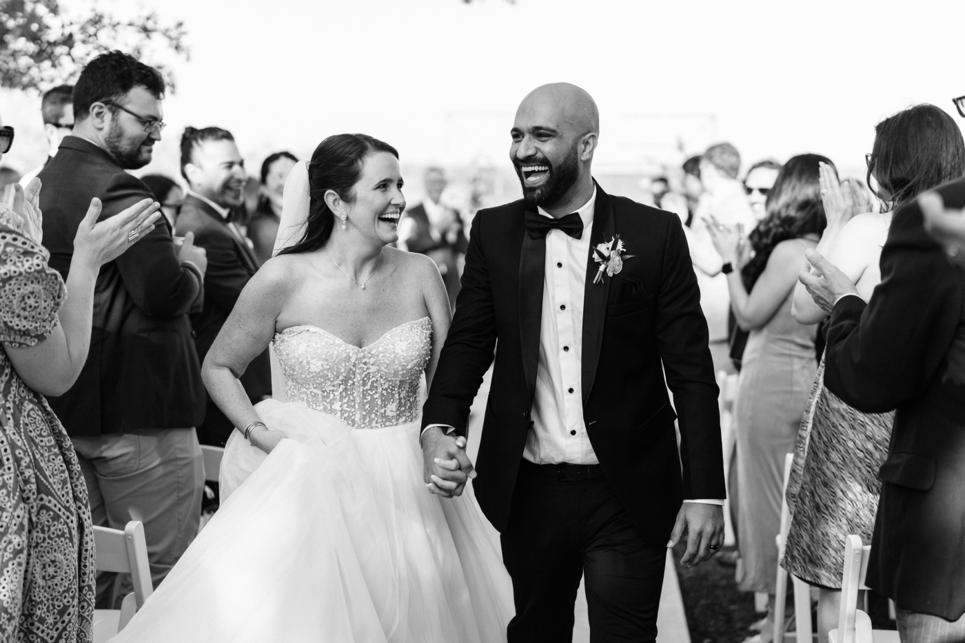 A bride and groom walk back up the aisle after their western wedding ceremony