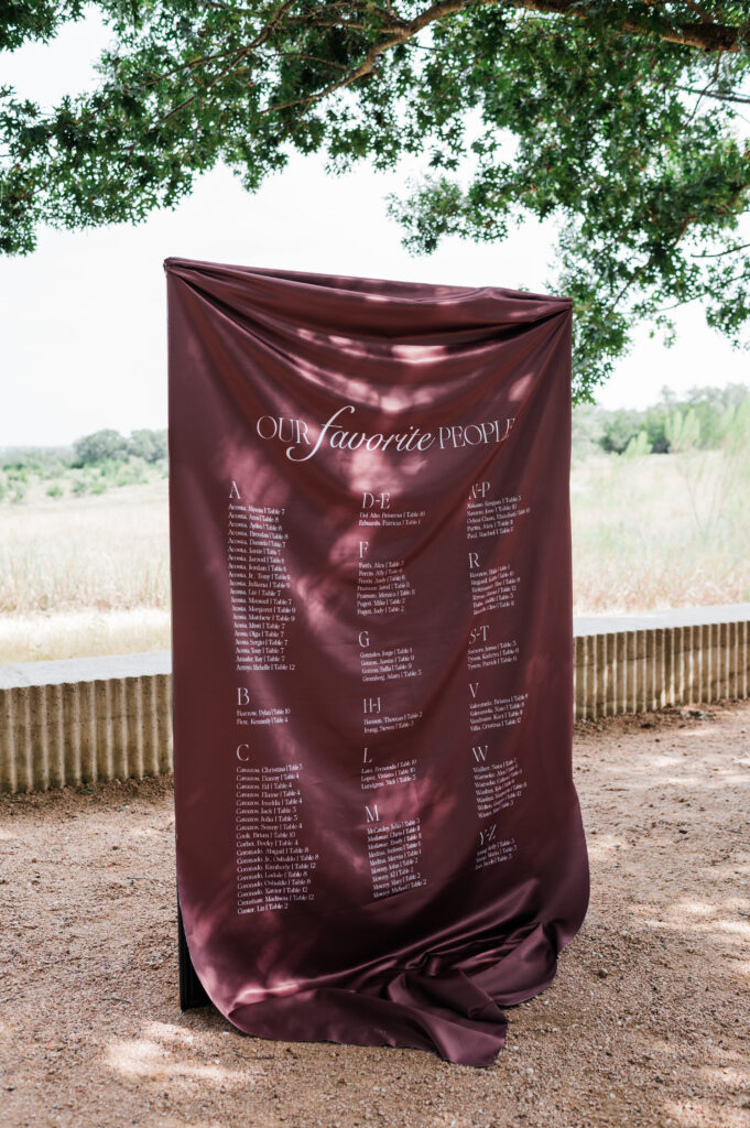 Burgundy draped wedding ceremony arch at Prospect House, an Austin wedding venue
