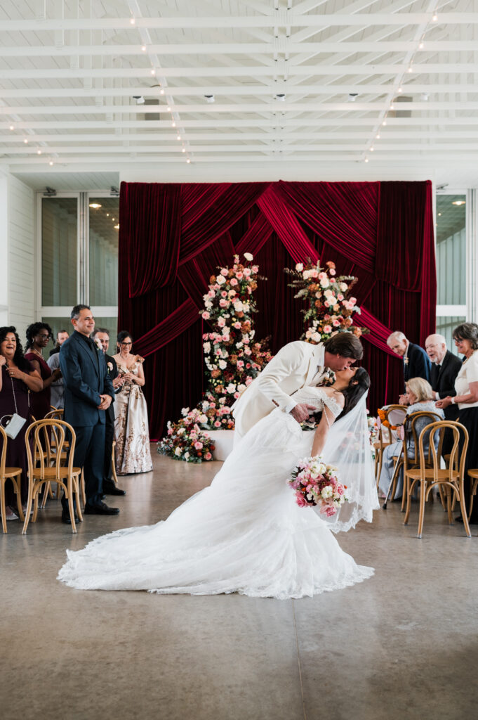 Burgundy draped wedding ceremony arch at Prospect House, an Austin wedding venue