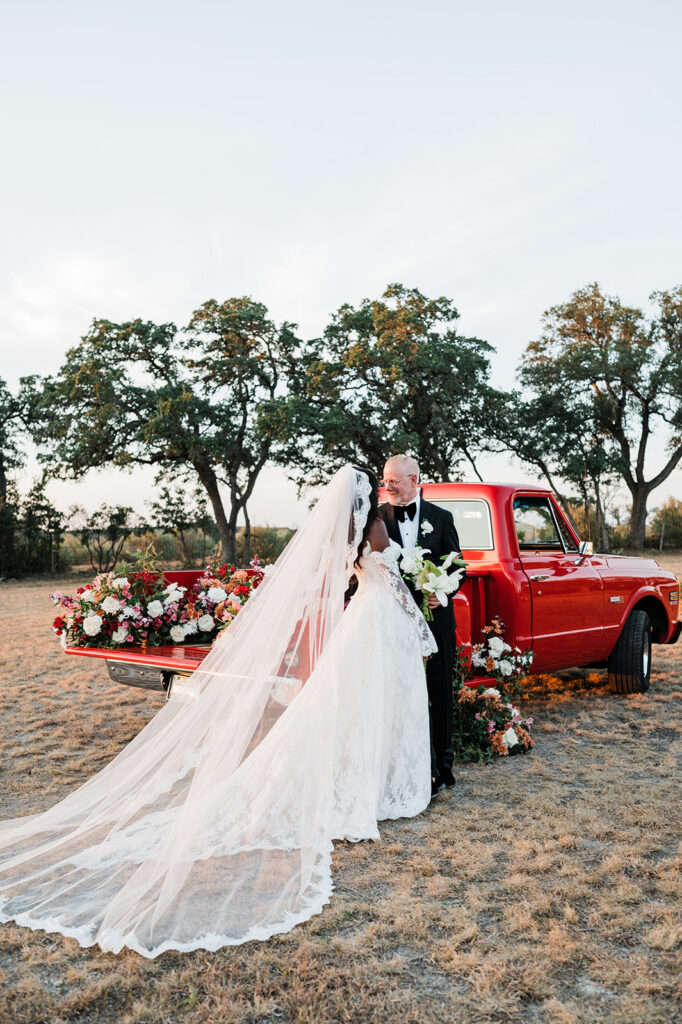 Quiana and David's golden hour portraits with a vintage red truck in Wimberley, TX