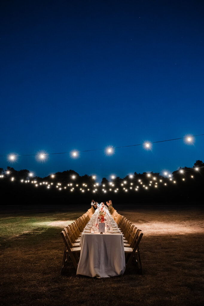 Candlelit long-table reception at Jacob's Well Vineyard in Wimberley, TX