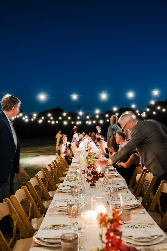 Candlelit long-table reception at Jacob's Well Vineyard in Wimberley, TX
